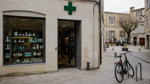 Façade d'une pharmacie indépendante sur une place de ville française.